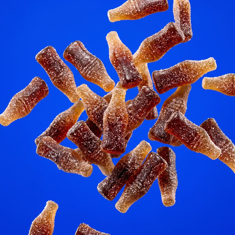 Fizzy cola-bottle sweets dusted in sour sugar